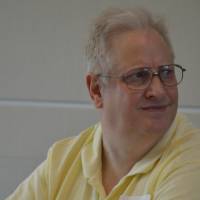 Alumnus sipping on wine and enjoying conversation